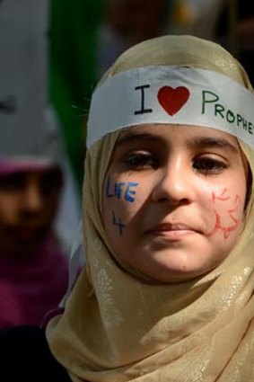 Protest rally ... a young Pakistani woman, her face adorned with the words "Life 4 Holy Prophet Mohammed" takes part in a demonstration in Islamabad on Saturday.