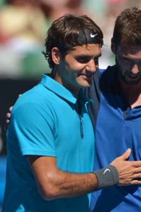 Bad luck: Roger Federer consoles Benoit Paire.