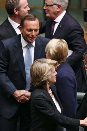 Prime Minister Tony Abbott shakes hands with Labor MP Jenny Macklin after delivering the Closing the Gap report.