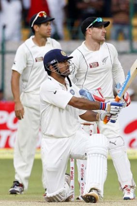 New Zealand's captain Ross Taylor (left) and wicketkeeper Brendon McCullum watch as India's captain Mahendra Singh Dhoni hits a six to win the Test for his country.