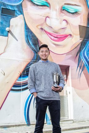 Andy Kieatiwong holding one of his next-generation rockets.