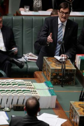 Greg Combet gestures towards Tony Abbott during a parliamentary debate in 2011.