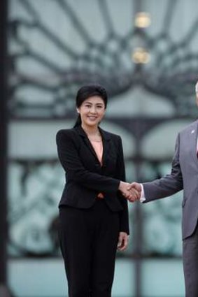The deal is done ... Prime Minister Yingluck Shinawatra, left, and her Malaysian counterpart Najib Razak shake hands.