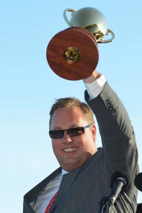 Nick Williams holds the Caulfield Cup aloft after Fawkner sped to victory.