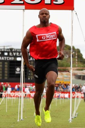Jamaican Asafa Powell reaches for his hamstring after his Stawell Gift heat.