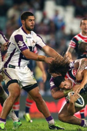 Cooper Cronk and Kevin Proctor of the Storm up end Mahe Fonua of the Roosters during the round 11 NRL match between the Sydney Roosters and the Melbourne Storm at Allianz Stadium on May 25, 2013 in Sydney, Australia.