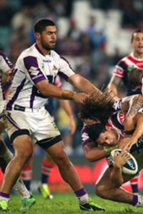 Cooper Cronk and Kevin Proctor of the Storm up end Mahe Fonua of the Roosters during the round 11 NRL match between the Sydney Roosters and the Melbourne Storm at Allianz Stadium on May 25, 2013 in Sydney, Australia.