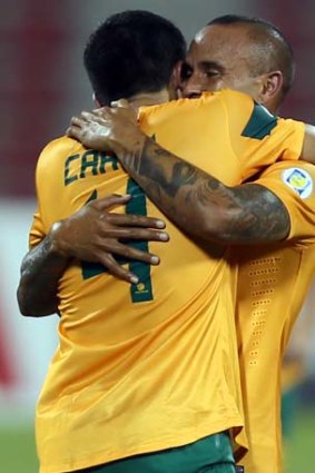 Old timers &#8230; Tim Cahill and Archie Thompson embrace.