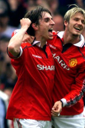 Gary Neville and David Beckham celebrate winning the FA Cup in 1999.