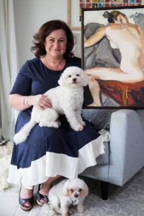 Cheryl Akle with her favourite object, a painting of a nude, and next favourite things, dogs John Brown and (below) George. 