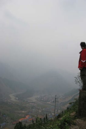 John Garnaut standing overlooking the flattened town of Beichuan, China.