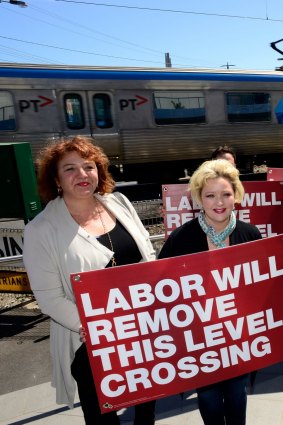 Opposition Leader Daniel Andrews and wife Cath at the Balcombe Road level crossing in Mentone, which, if elected his government would remove.