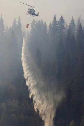 A helicopter drops water on the King fire in Pacific House, north-east of the Californian capital Sacramento.