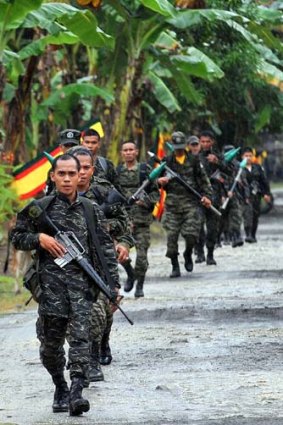 Hopes to lay down their arms ... Moro Islamic Liberation Front rebels patrolling on the southern Philippine island of Mindanao.