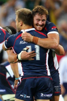 Scott Higginbotham and Lachlan Mitchell of the Rebels celebrate.