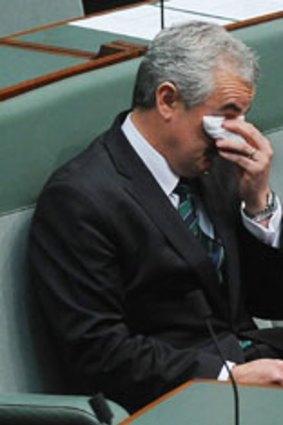 Independent Andrew Wilkie wipes away tears after concluding his anti Afghanistan war speech.