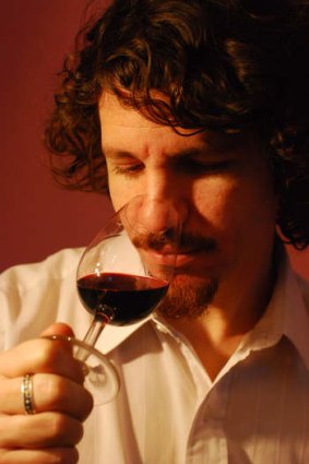 Casa Coupage owner and sommelier investigates a wine.