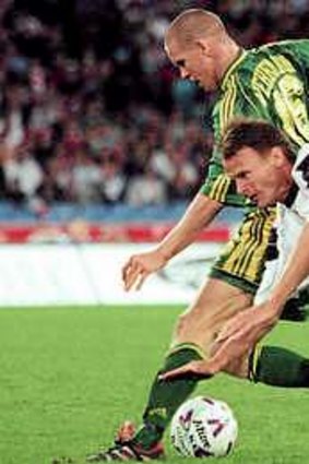 Hits and memories: Terry Sheringham goes flying in a previous visit by Manchester United in 1999 when they beat the Socceroos 2-0 in a series marred by a broken leg to Simon Colosimo.