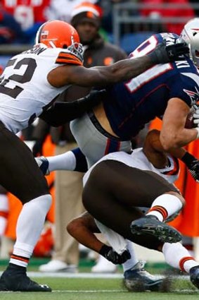 Rob Gronkowski is hit low by T.J. Ward.