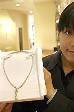 The George restaurant host Yuki Mo shows a valuable necklace left behind by a mystery guest.