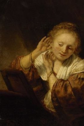 Rembrandt's Young Woman Trying on Earrings.
