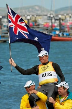 The Australian sailing team mobs Tom Slingsby after his gold medal-winning race in Weymouth Portland on England's South Coast.
