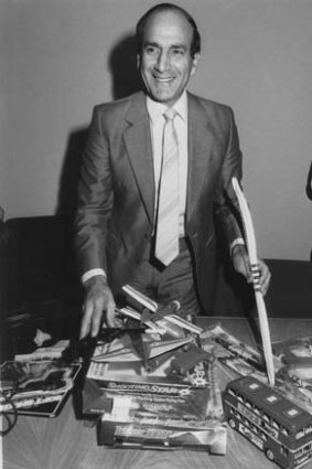 On the job &#8230; George Paciullo as consumer affairs minister, with an array of dangerous toys.