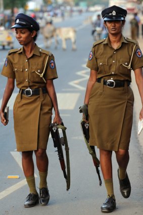 Tense situation ... policewomen with automatic weapons patrol the streets.