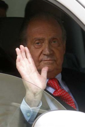Rushed back ... Spain's King Jaun Carlos emerges from hospital after being treated for a fractured hip.
