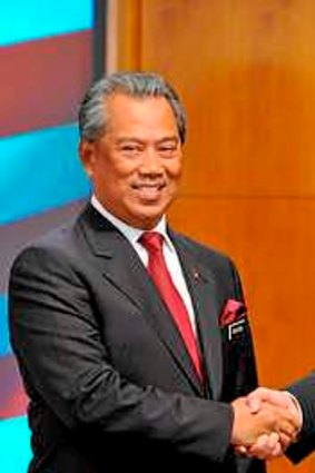 Malaysia's Prime Minister Najib Razak (right) shakes hands with his deputy Muhyiddin Yassin after announcing his cabinet line-up in Putrajaya.