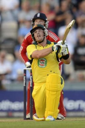 Aaron Finch hits a six watched by England's Jos Buttler.
