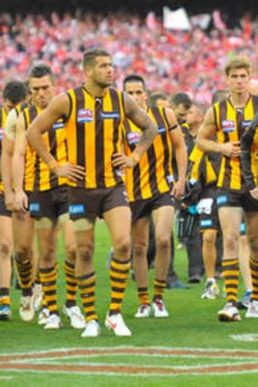 Lance Franklin and Luke Hodge lead the teammates from the ground after their loss to Sydney.