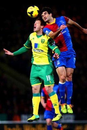 Mile Jedinak (right) in an aerial contest with Luciano Becchio of Norwich.
