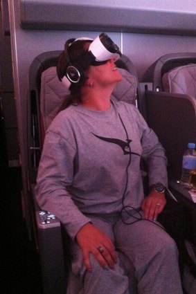 World first: The author tries out the new virtual reality experience on board a Qantas flight.