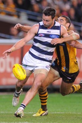Burgoyne tackles Geelong's Jimmy Bartel in the final quarter; the ball went to Bradley Hill who goaled.