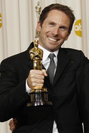 Kirk Baxter poses backstage last year, with his Oscar for best film editing for 'The Social Network'.