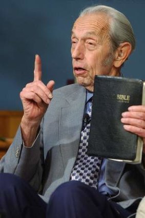 A prophet, with profits:  Harold Camping holds a Bible as he makes his live television broadcast in San Leandro, California. AP