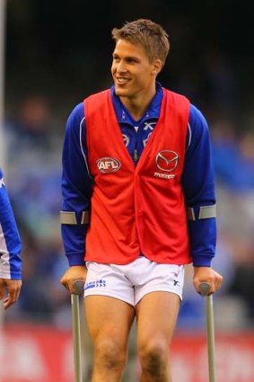 Andrew Swallow leaves the field on crutches during the round 18 match against Melbourne on July 27, 2013.
