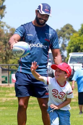 Kurtley Beale with Aiden Inglis, 6, at the Rebels clinic at Frankston.