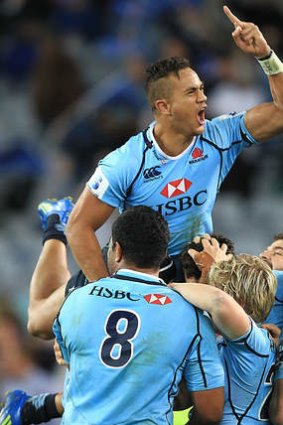 Peter Betham celebrates a try with Waratahs teammates during the 2013 season.