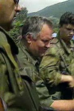 Video footage from 1995 shows a grinning Ratko Mladic patting the head of Izudin Alic.