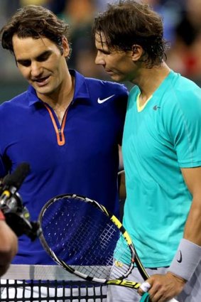 Old friends: Roger Federer congratulates Rafael Nadal.