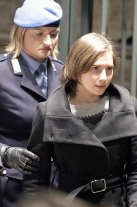 "That girl is not me" ... Amanda Knox is escorted by a guard to her appeal hearing on Saturday.