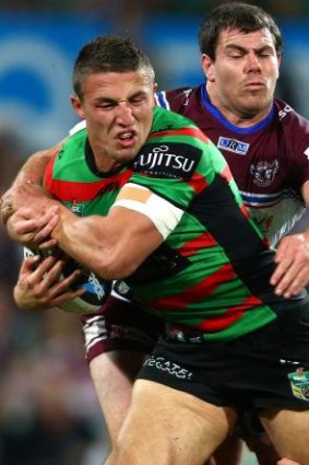 Powerhouse: Sam Burgess smashes his way through the Manly defence at the SCG.