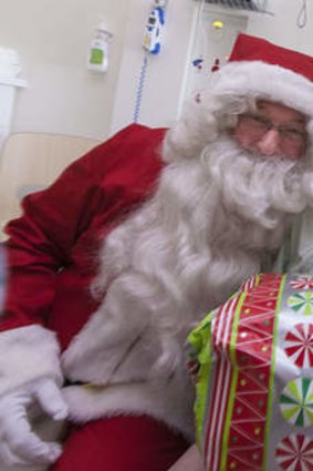 Jack Fox enjoys Santa's visit at the Royal Children's Hospital.