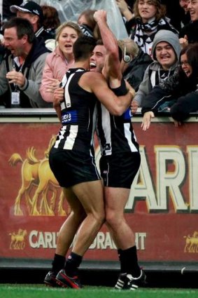 Magpies midfielder Jarryd Blair (right) is congratulated by teammate Sharrod Wellingham on Anzac Day.
