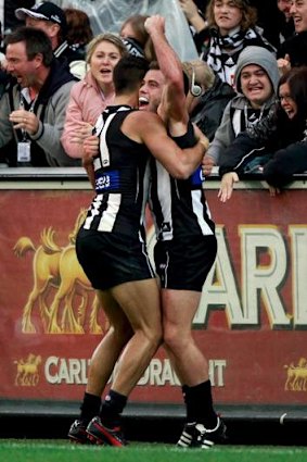 Magpies midfielder Jarryd Blair (right) is congratulated by teammate Sharrod Wellingham on Anzac Day.