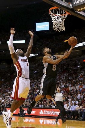 Developing: Patty Mills shoots despite the efforts of LeBron James.