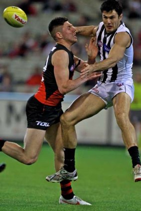 Chris Tarrant, seen here being put under pressure by Bombers rookie Michael O'Brien in a marking contest, believes the Pies' smaller forward mix in round 23 was less predictable and more efficient.