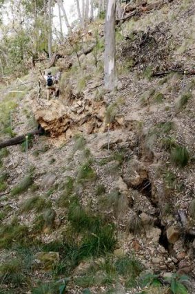 A massive fracture running up the hillside.